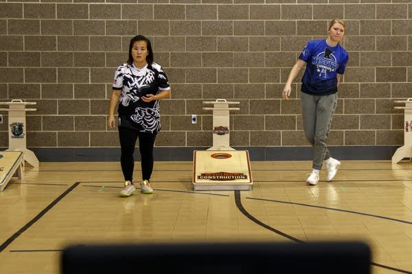 People play cornhole together