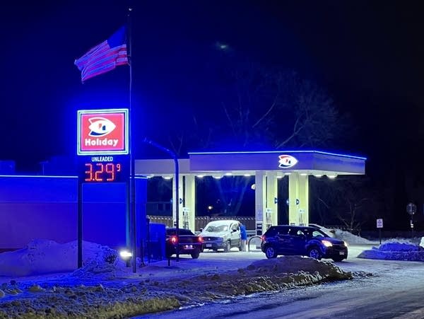A gas station and convenience store at night