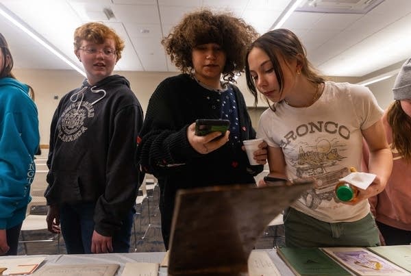 Students look in a time capsule