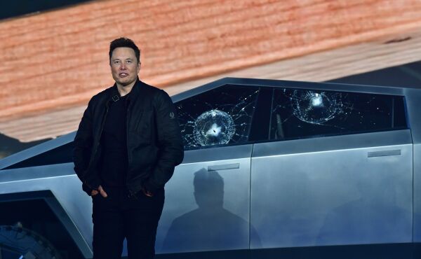 Musk stands in front of the shattered windows of the newly unveiled Tesla Cybertruck on Nov. 21, 2019. Musk has claimed the vehicle is bulletproof though experts say the 7,000 pound truck would need additional armoring to meet State Department standards.