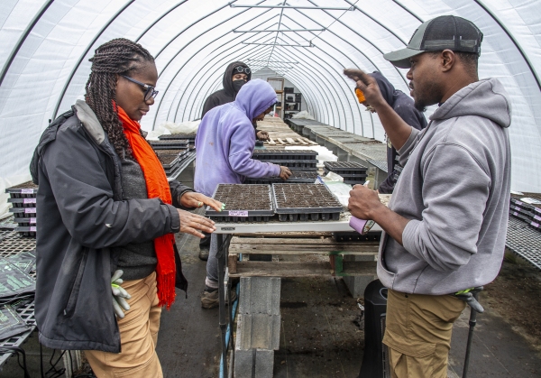 February 6, 2025 Farmer Gale Livingstone alongside volunteers Sydney Harris, Lewis Taylor, Emmani Phillips-Quigley and Jimi Palmer plant seeds at Deep Roots Farm in Upper Marlboro, Md. Photo by Dee Dwyer for NPR