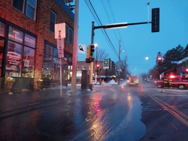 Water fills the street near a building.