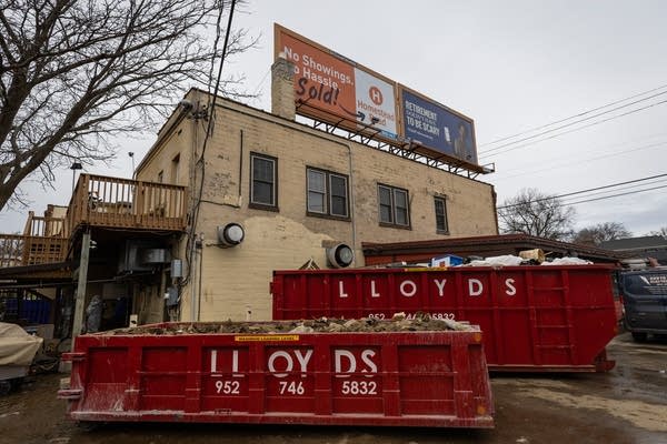 Two large red dumpsters