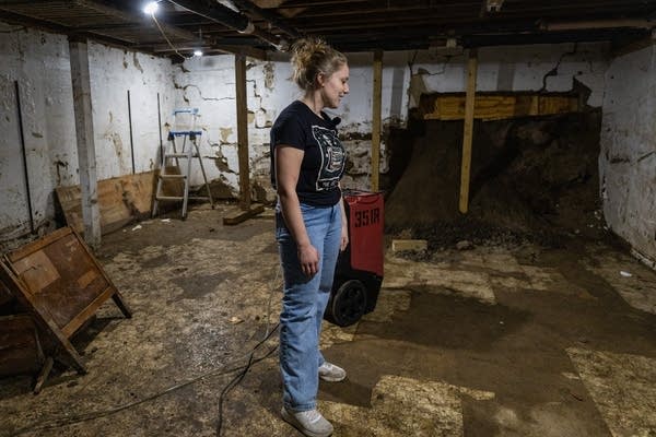 A woman stands in a basement