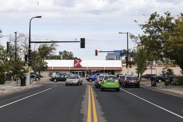 Vehicles pass the intersection at Nicollet Avenue and E Lake Street. 