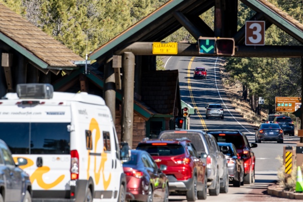 Vehicles wait in line at an entrance to the Grand Canyon National Park. 