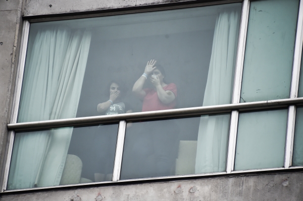 Migrants deported from the United States wave to the press from inside a hotel in Panama City on Wednesday.