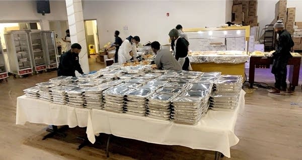 aluminum food trays piled on table