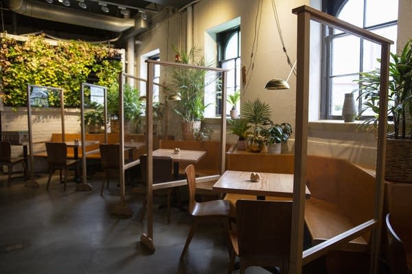 Movable partitions divide tables in a restaurant. 