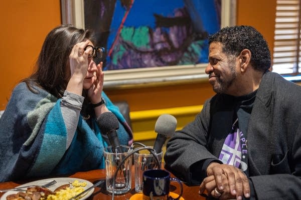 Two people dine at a cafe table