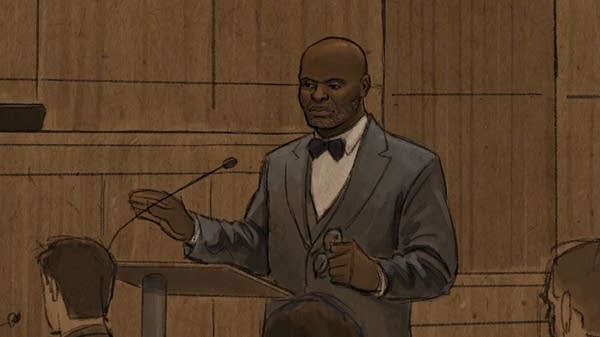 Man speaks at podium in court.