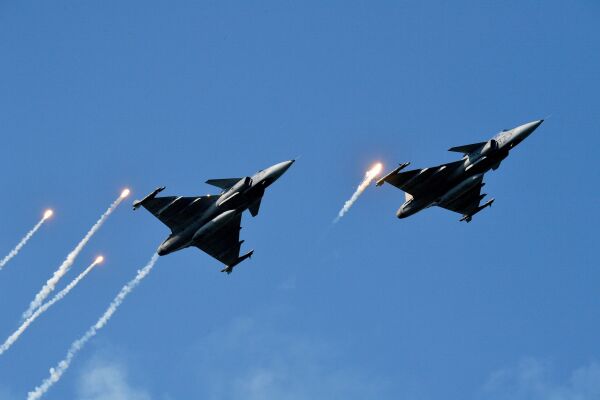 Gripen fighter jets of the Hungarian Air Force fire their infrared countermeasure over the Danube River in Budapest on Aug. 20, 2019, during an air show.