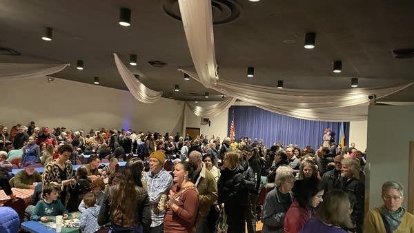 A large crowd sits for a meal