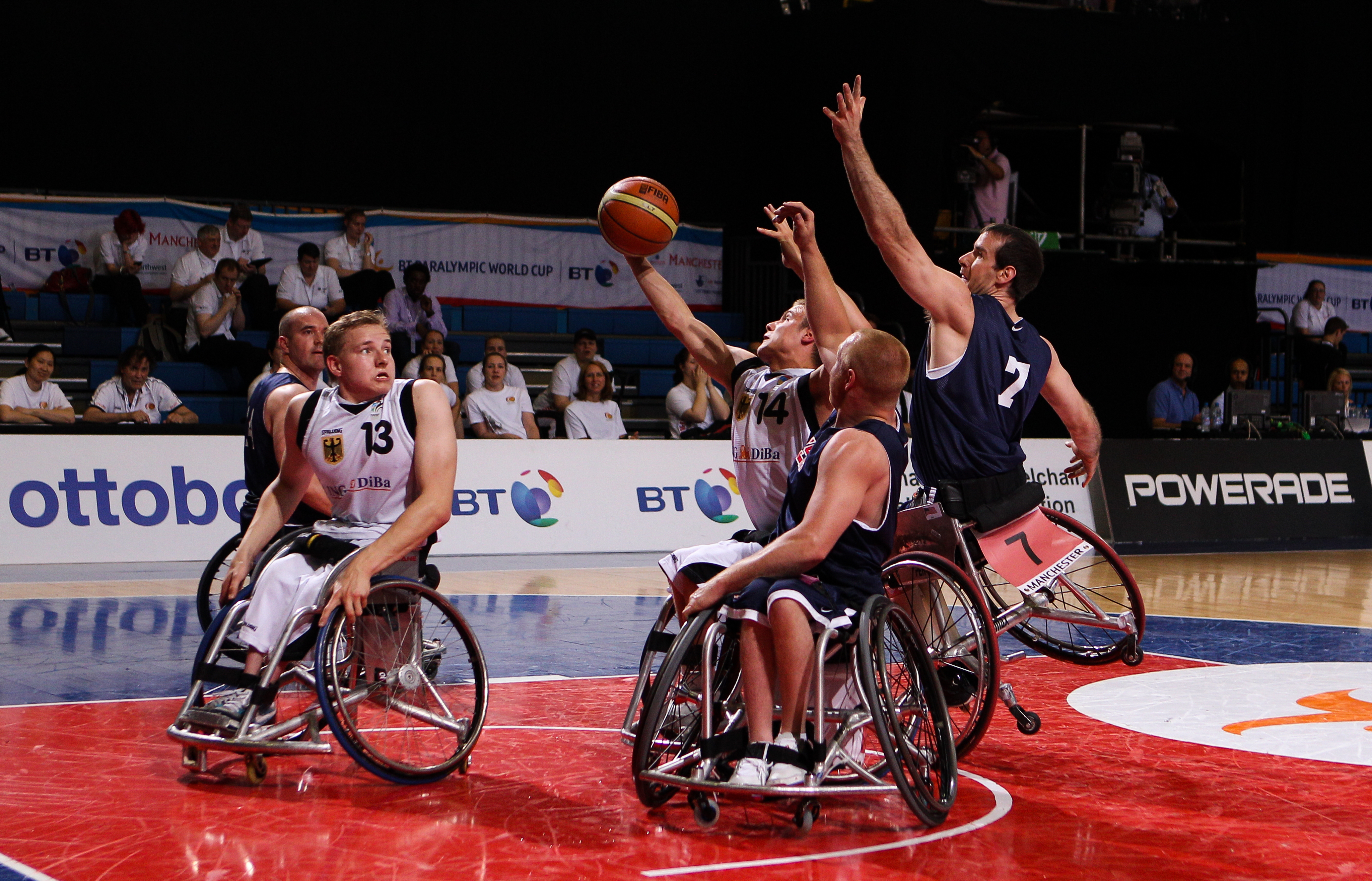 Two competing wheelchair basketball players compete the ball at the Paralympics.