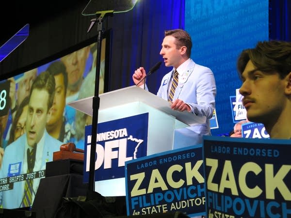 A man speaks at a podium
