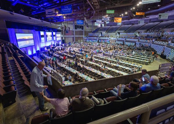 Wide shot of guests arriving in a convention center.