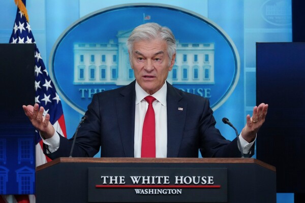 Dr. Mehmet Oz is seen at a podium that says