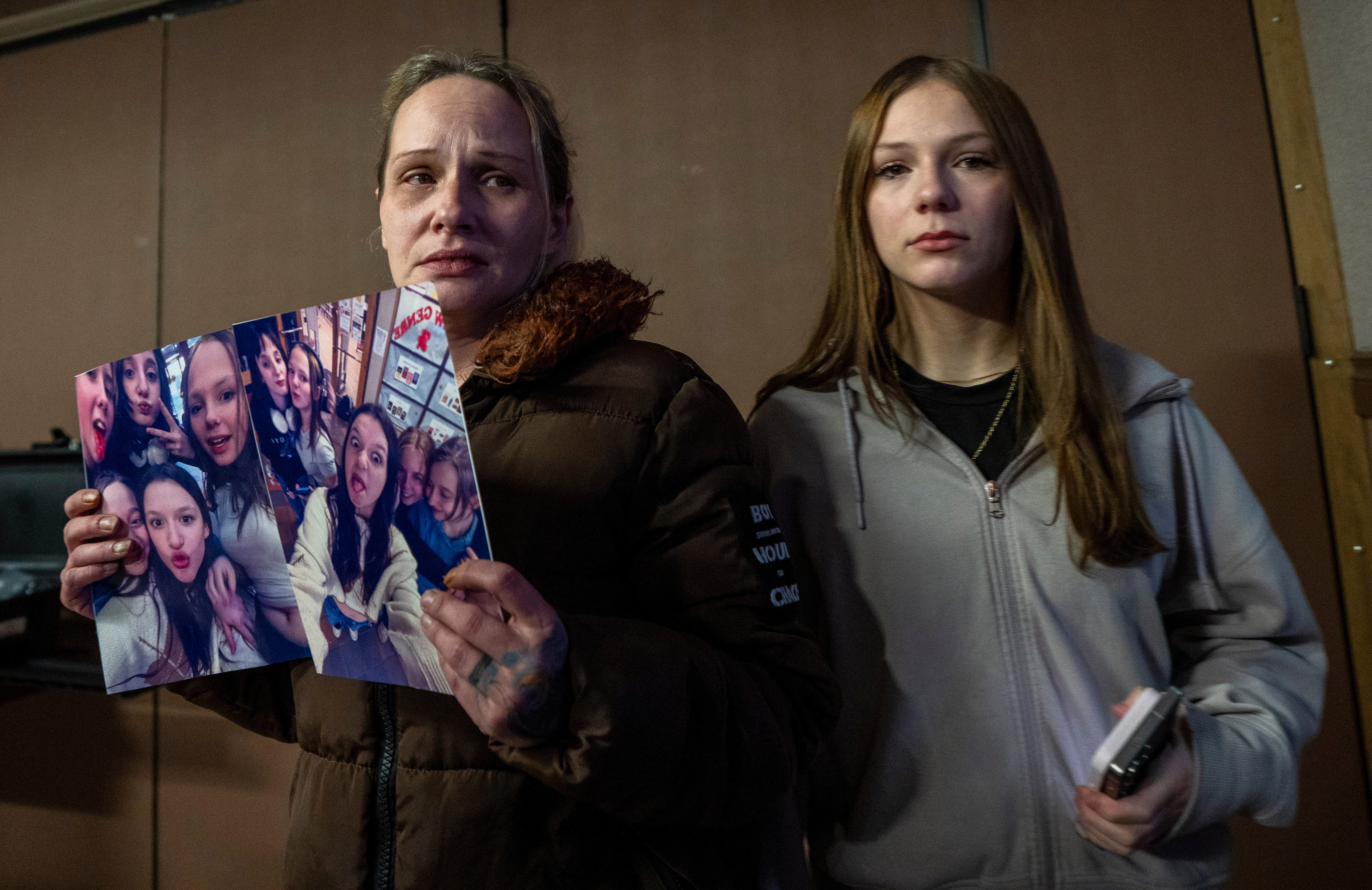 Sarah Lampert, left, stands with her daughter Niveya, right, as she holds photos of her daughter Ticaria, 12, who was a victim of the mass shooting, in Tumbler Ridge, British Columbia, Thursday, Feb. 12, 2026.
