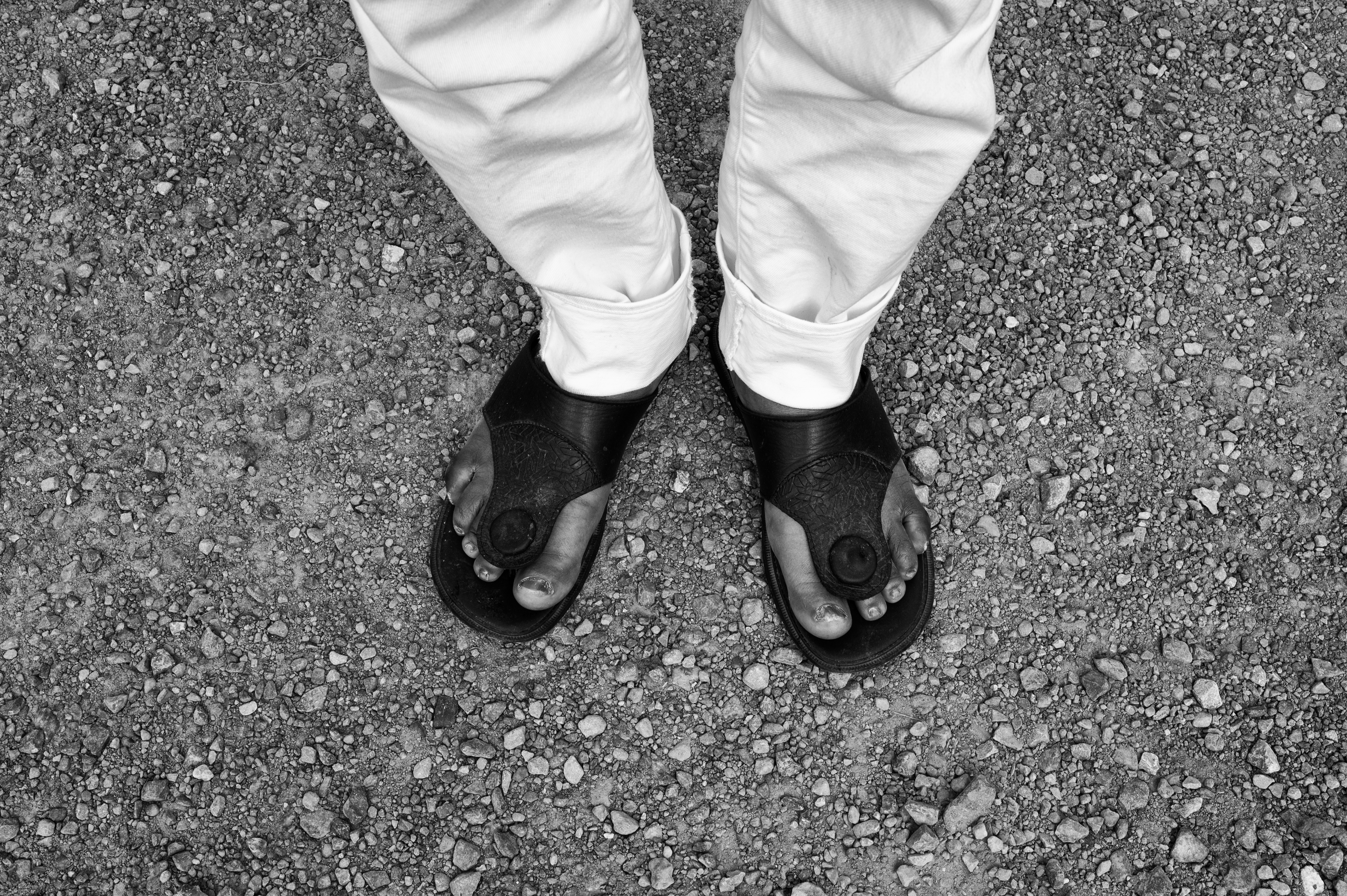 View of person's feet, wearing open-toed shoes.