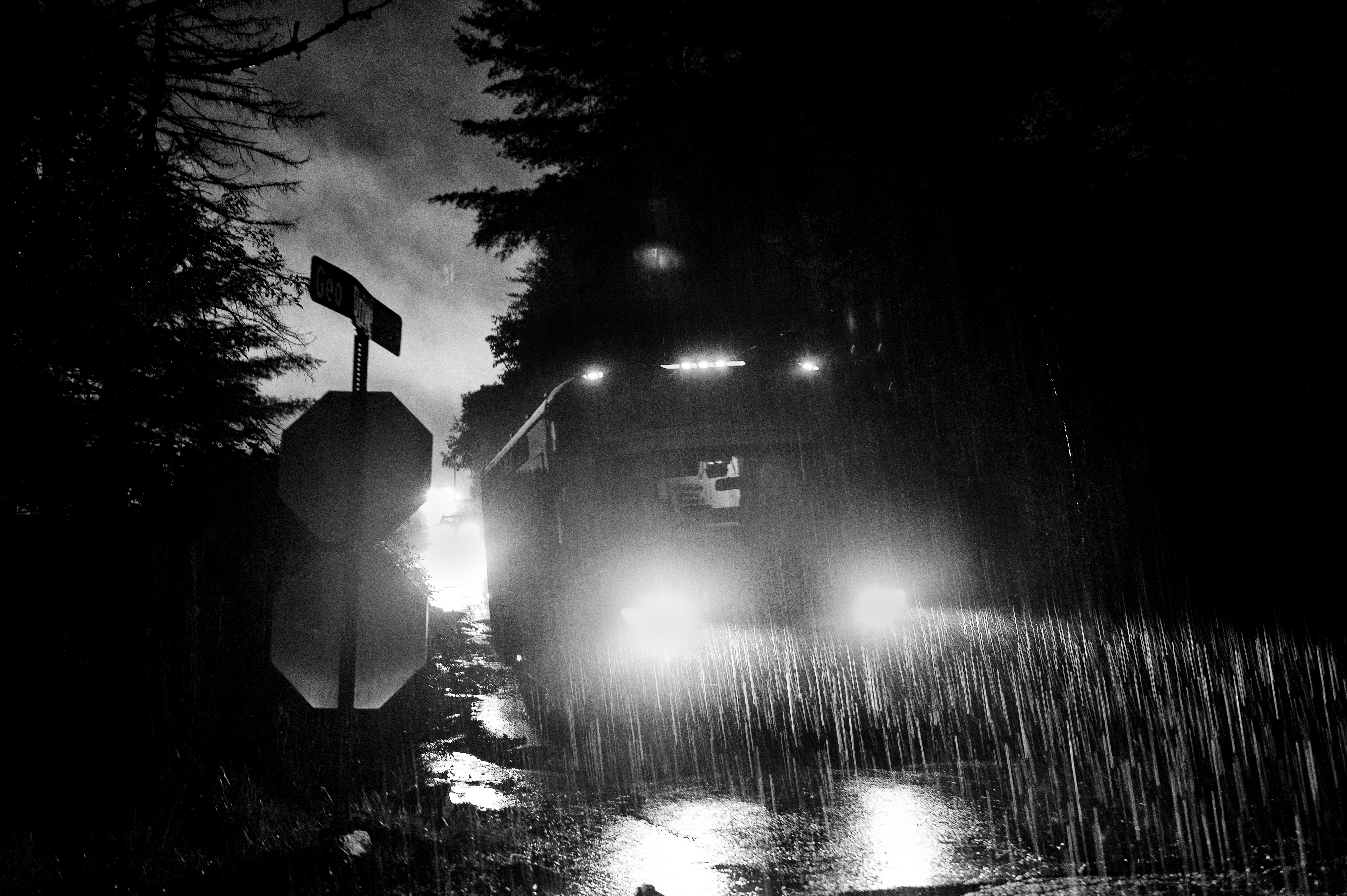 Bus driving at night in the rain. 