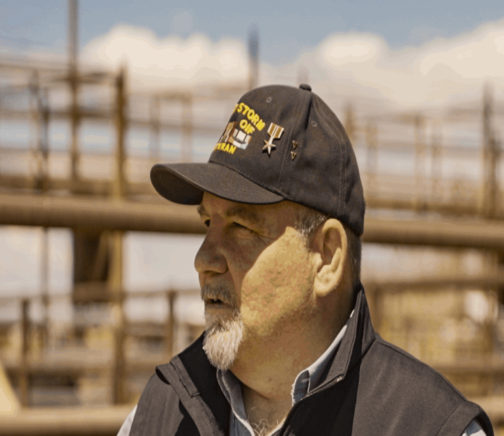 An image of David Flippo wearing a hat with a Bronze star and two V-shaped emblemds.