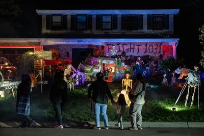 People look at an elaborate Halloween display