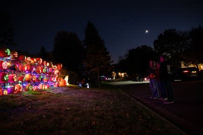 People admire an elaborate Halloween display 