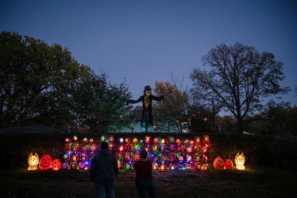 A large Halloween display with lit pumpkins