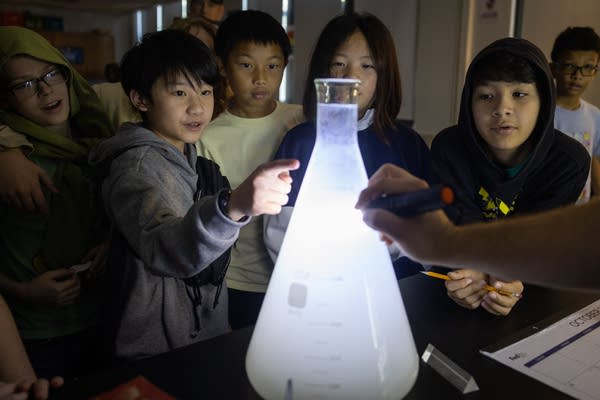 Kids gather around an experiment