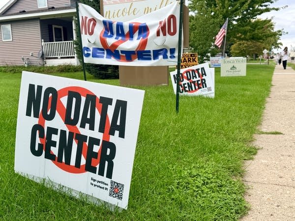 Yard signs saying "NO DATA CENTER" are posted in the grass.