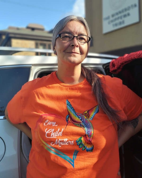 A woman in an orange T-shirt