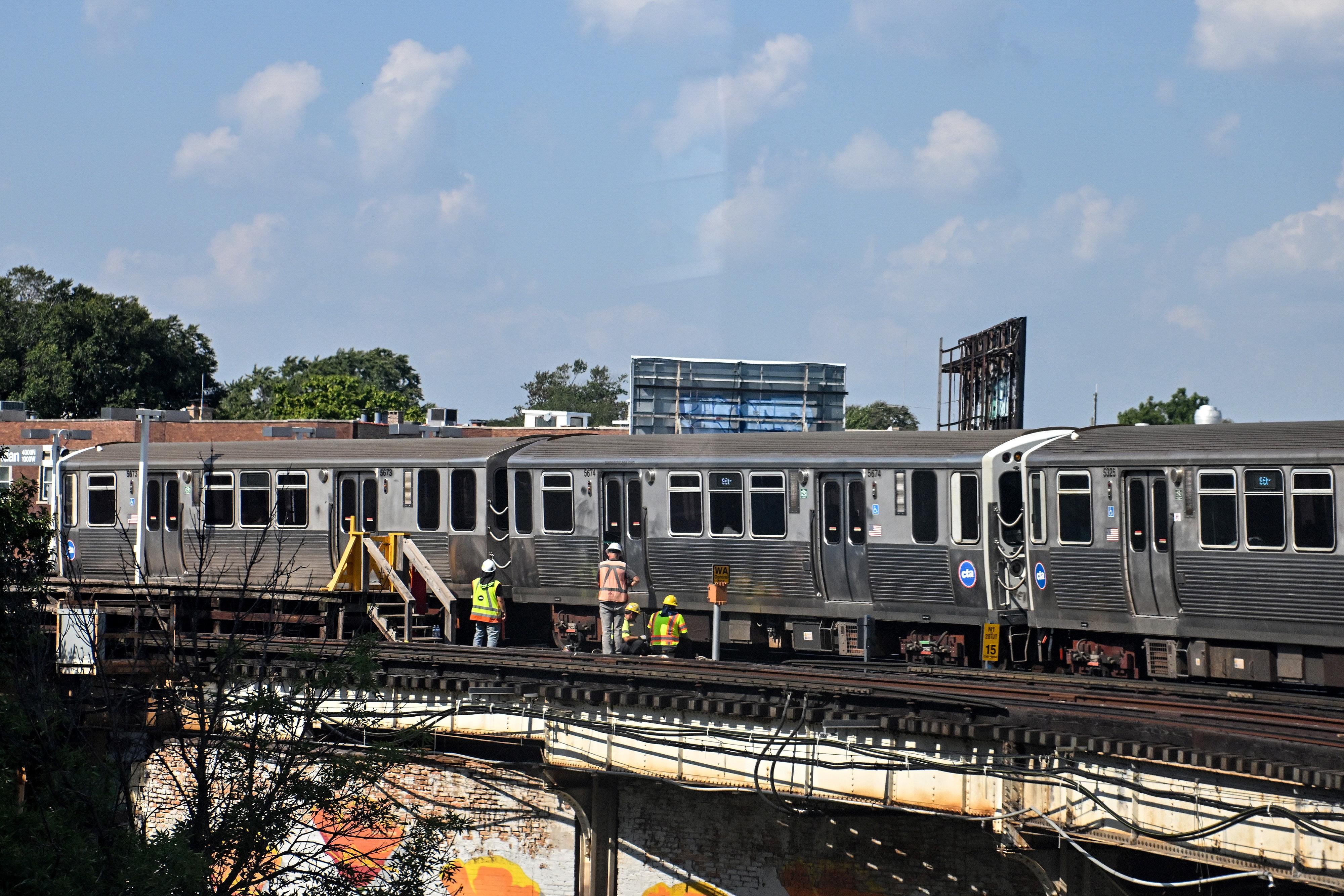 People working on an above ground subway